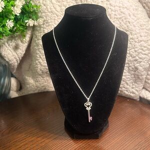 Silver-tone necklace with rhinestone topped key pendant